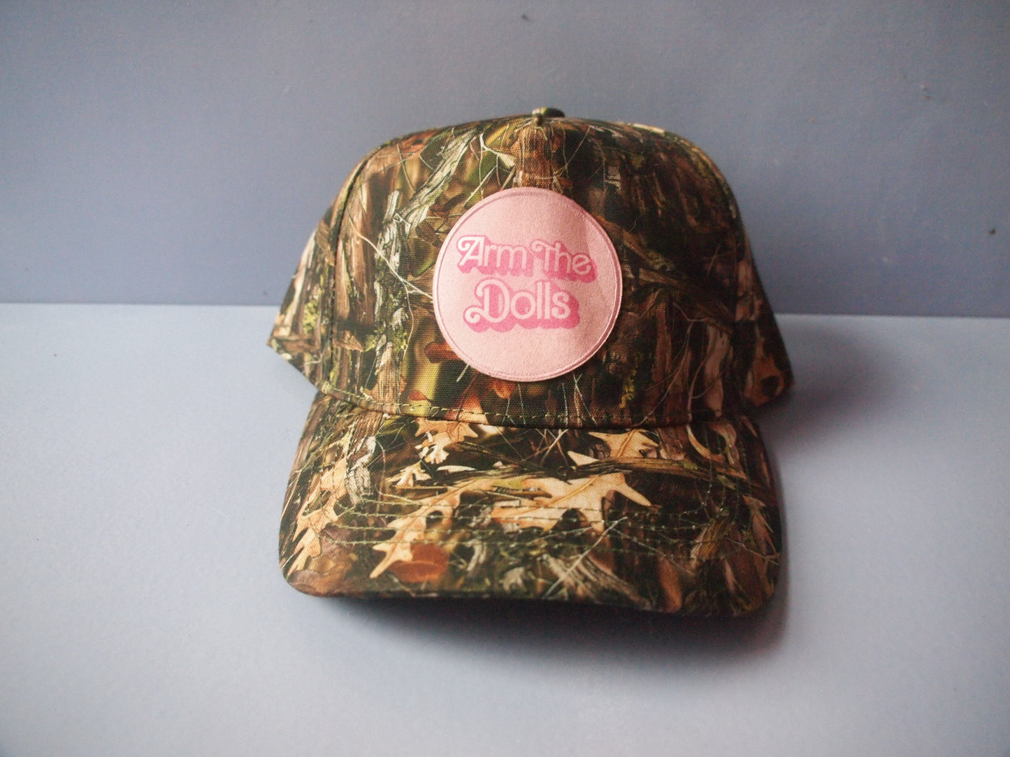 "Arm The Dolls" Camo Snapback Hat