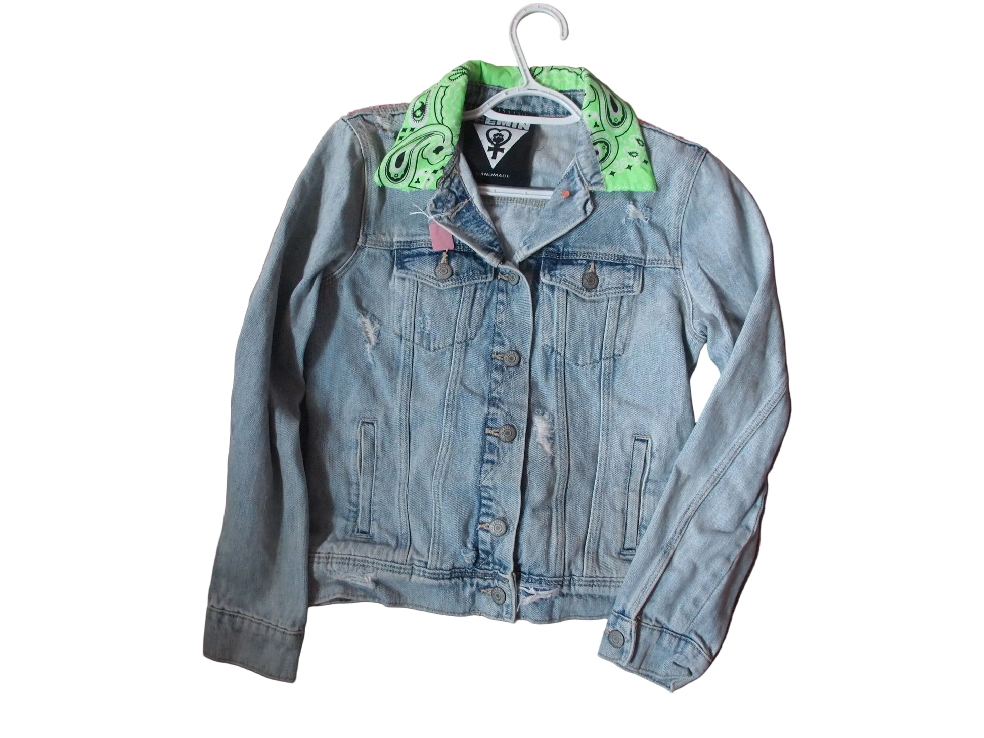A light blue distressed denim jacket with a bright green paisley bandana collar.